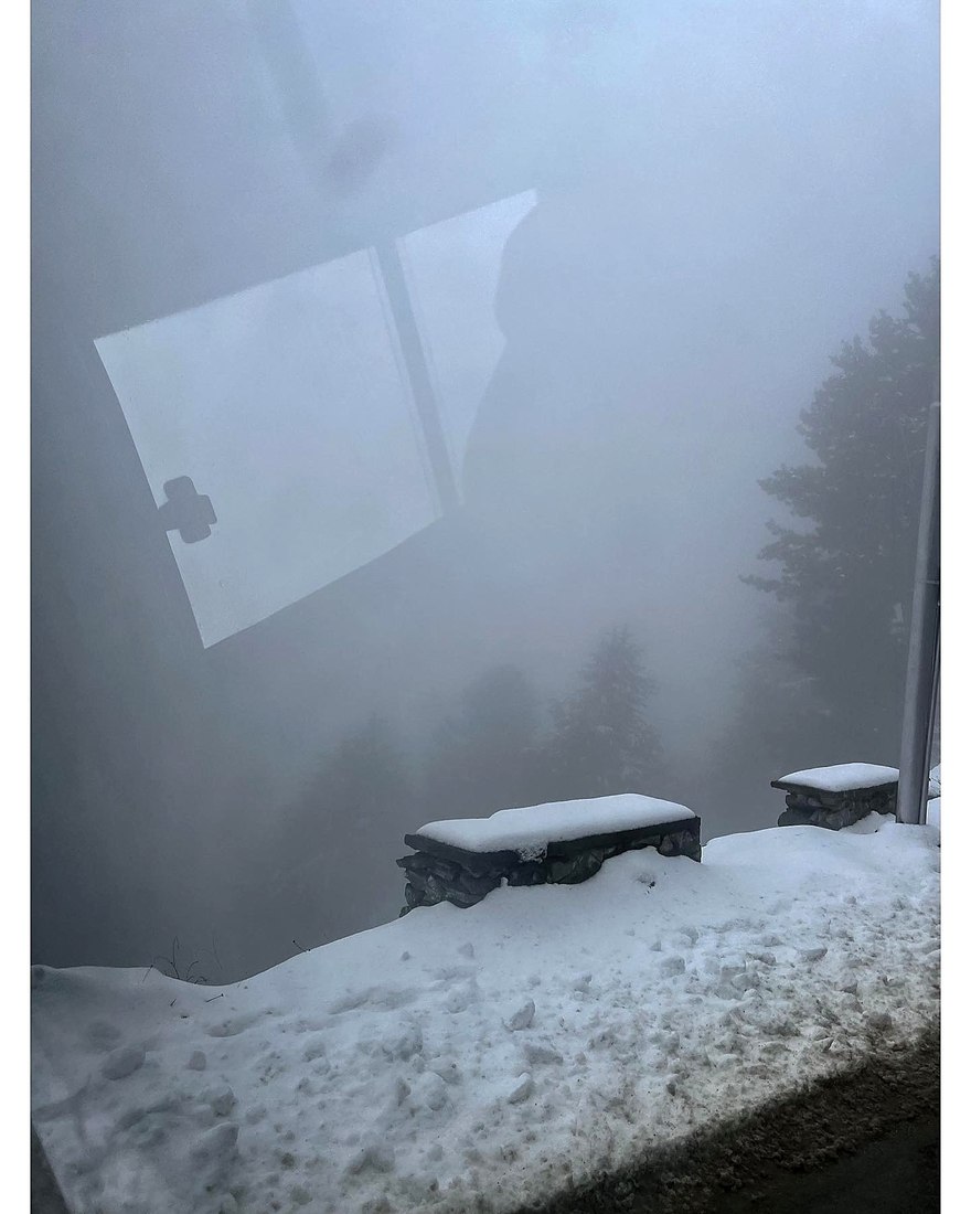 A snow-covered viewpoint wrapped in fog in the mountains of Kashmir