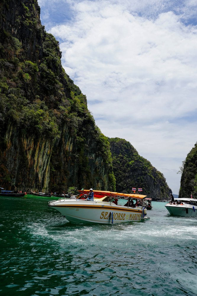 A tour boat passing between limestone cliffs near Krabi, Thailand